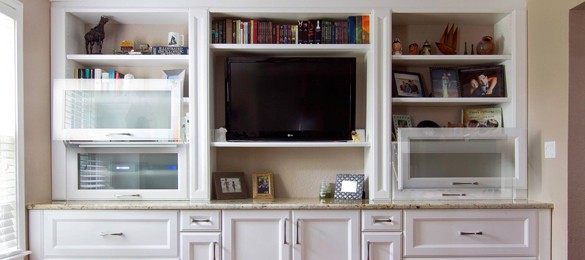 white entertainment center showing how the cabinet doors slide upwards